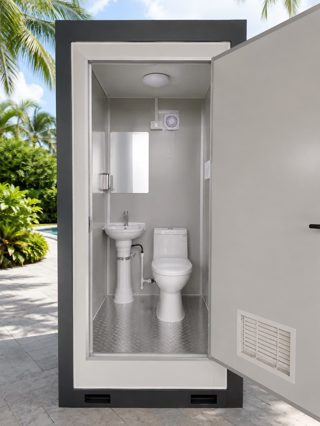 NOVAMOD Pool Bathroom interior — toilet and sink with tropical garden view